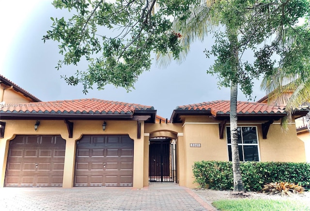 mediterranean / spanish-style home with a garage