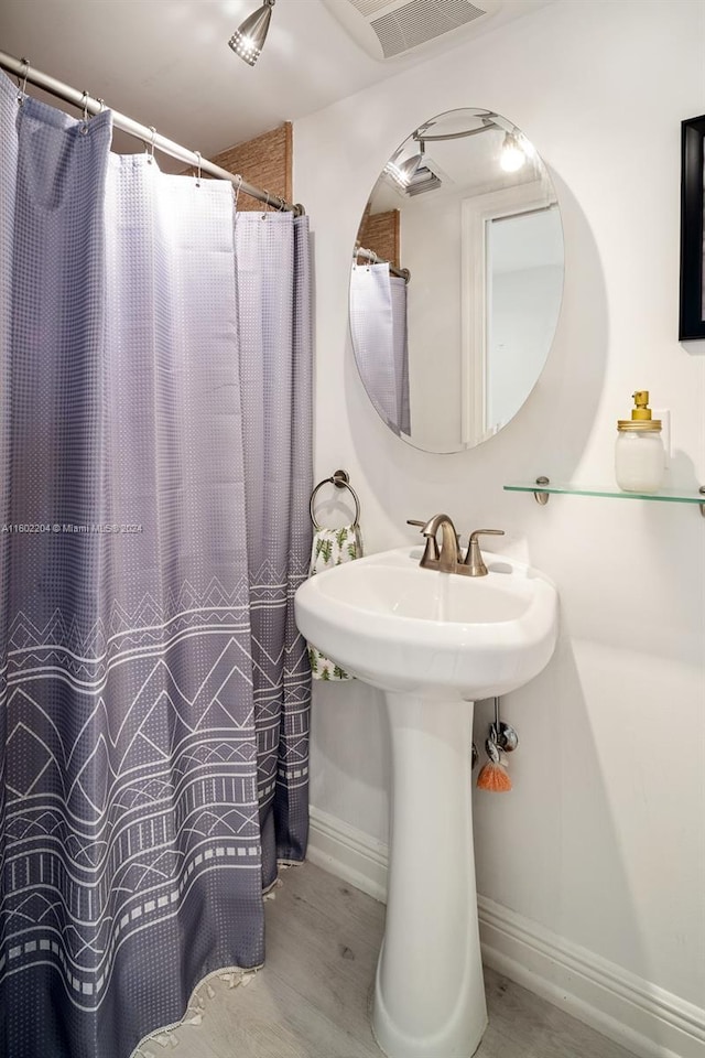 bathroom with wood-type flooring