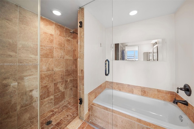 bathroom featuring separate shower and tub