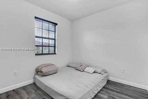 bedroom featuring dark hardwood / wood-style flooring