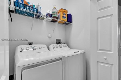 laundry room with washing machine and dryer and hookup for a washing machine