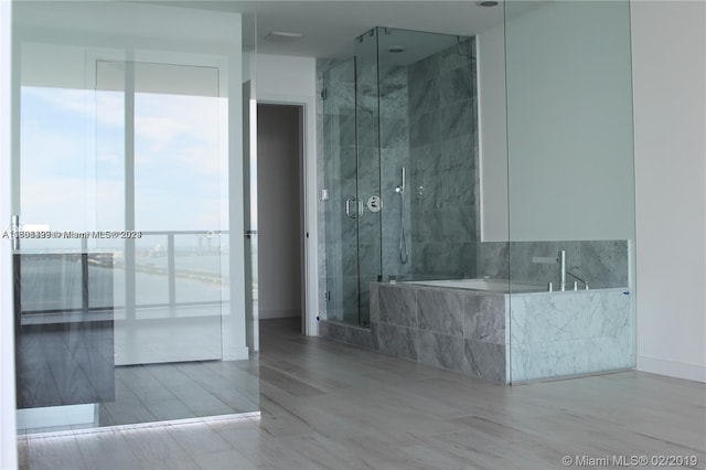 bathroom with shower with separate bathtub