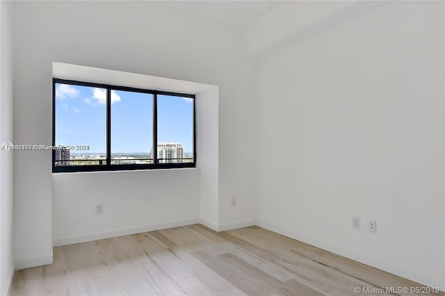 empty room with light hardwood / wood-style floors