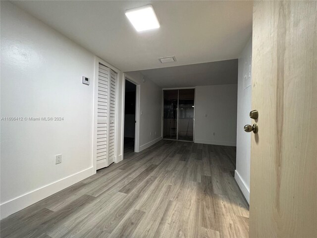 corridor with light hardwood / wood-style floors