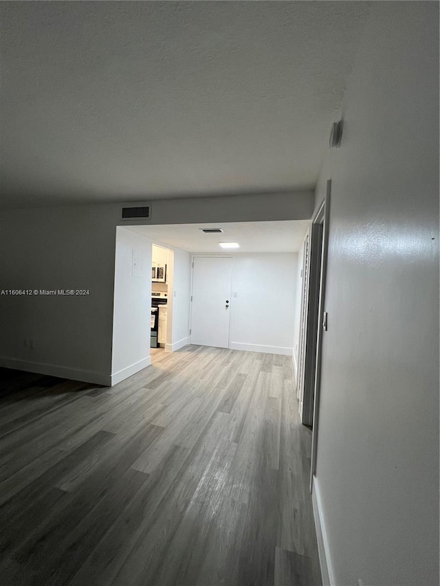 unfurnished living room with hardwood / wood-style floors