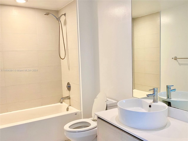 full bathroom featuring vanity, toilet, and tiled shower / bath