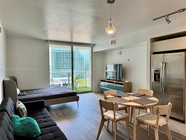 4250 Biscayne Blvd Unit 806, Miami, FL 33137 - living room with light wood-type flooring, baseboards, a wall of windows, and visible vents