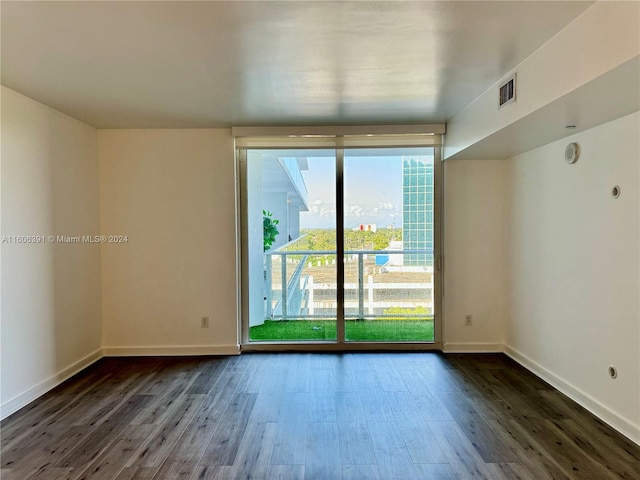 empty room featuring dark wood-type flooring