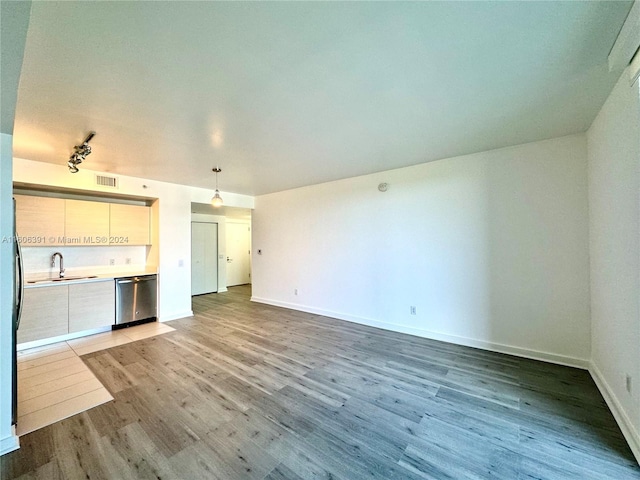 kitchen with light hardwood / wood-style flooring, dishwasher, and hanging light fixtures