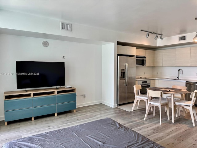 4250 Biscayne Blvd Unit 806, Miami, FL 33137 - living room featuring light wood-type flooring, baseboards, visible vents, and rail lighting