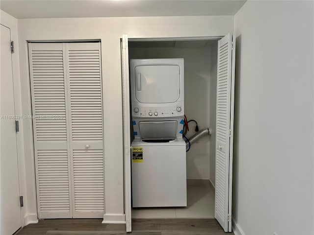4250 Biscayne Blvd Unit 806, Miami, FL 33137 - clothes washing area with baseboards, wood finished floors, stacked washer / dryer, and laundry area