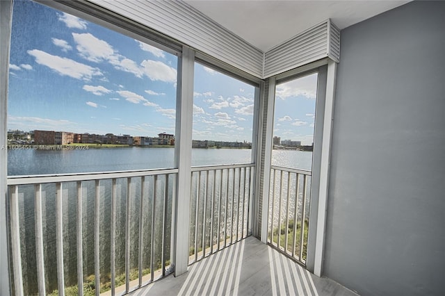 unfurnished sunroom featuring a water view