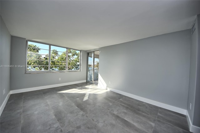 empty room with dark tile flooring