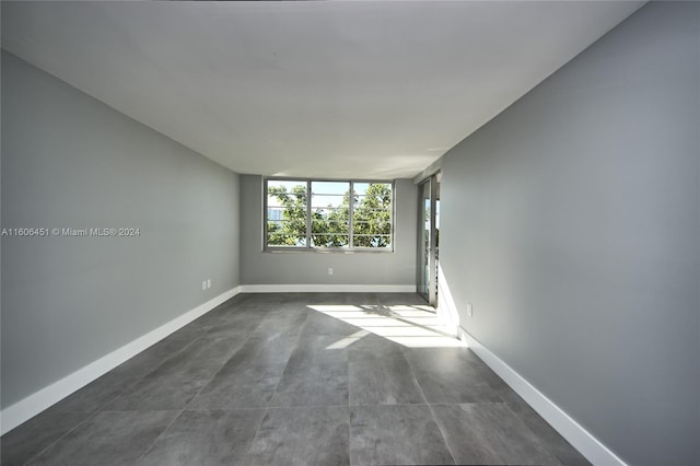 unfurnished room featuring tile flooring