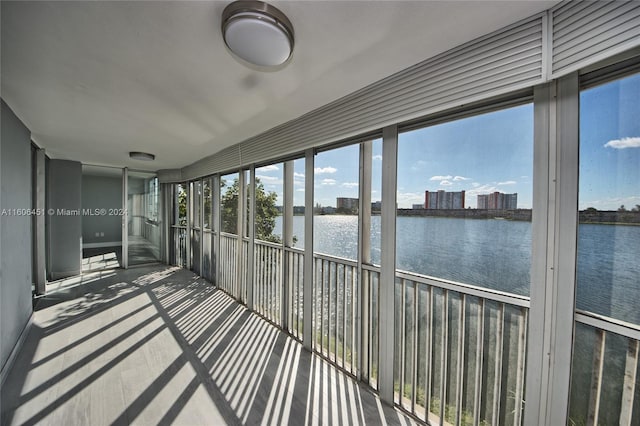 unfurnished sunroom with a water view