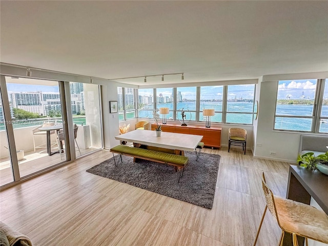 interior space with a water view and light hardwood / wood-style floors