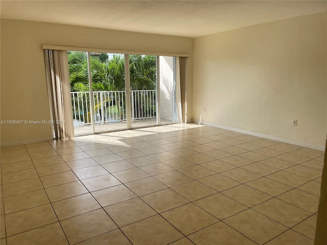 tiled spare room featuring plenty of natural light and a textured ceiling