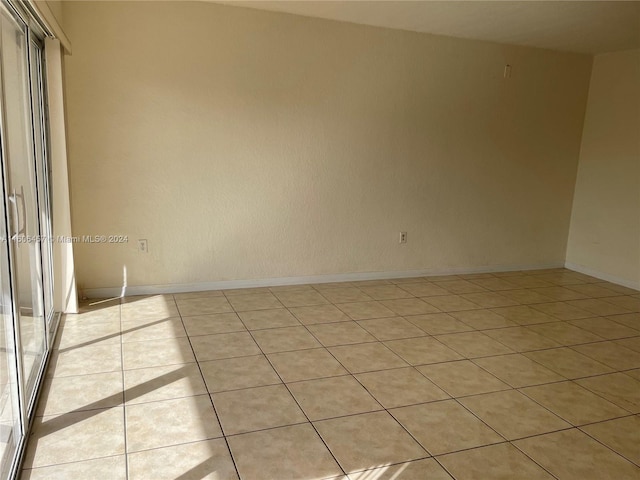 unfurnished room featuring light tile floors