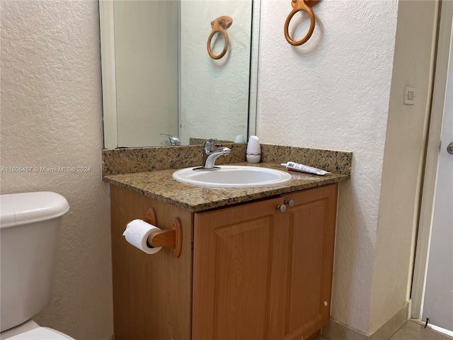 bathroom with toilet and vanity