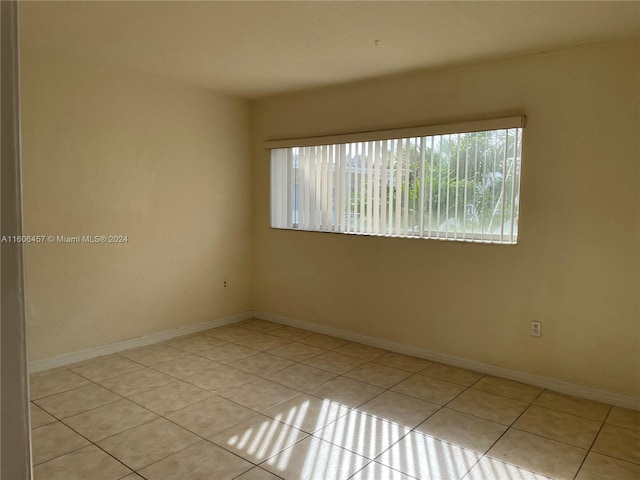 unfurnished room with light tile flooring