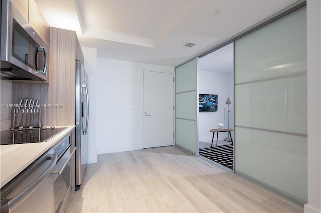 kitchen featuring light hardwood / wood-style flooring and appliances with stainless steel finishes