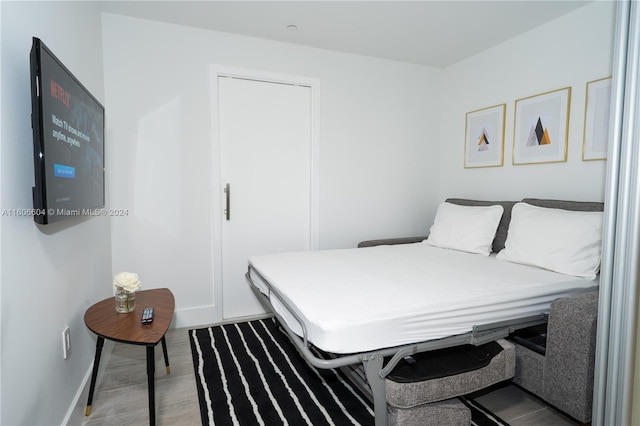 bedroom with wood-type flooring