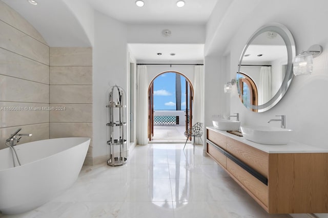 bathroom with a bath, tile flooring, and double vanity