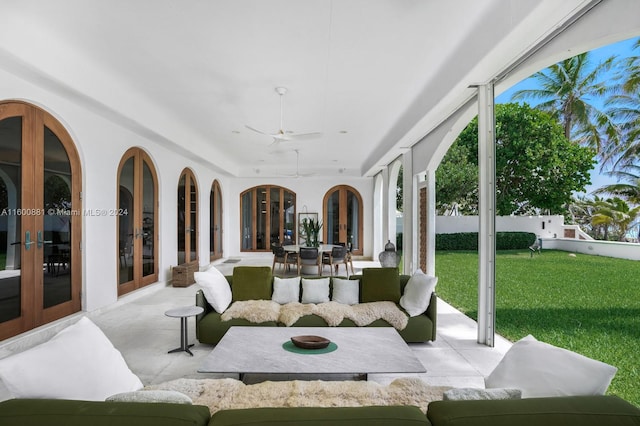 sunroom / solarium with ceiling fan and french doors