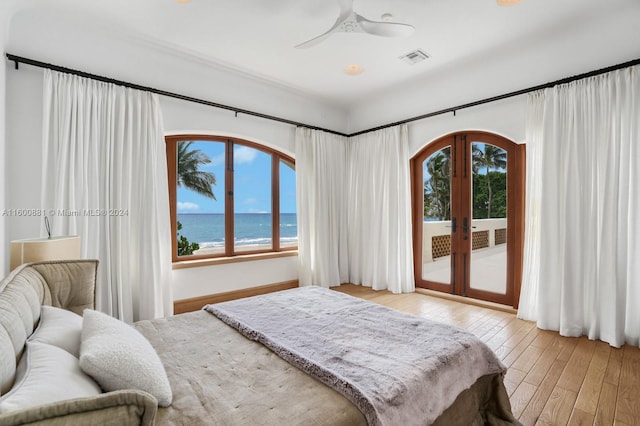 bedroom with ceiling fan, multiple windows, french doors, and access to exterior