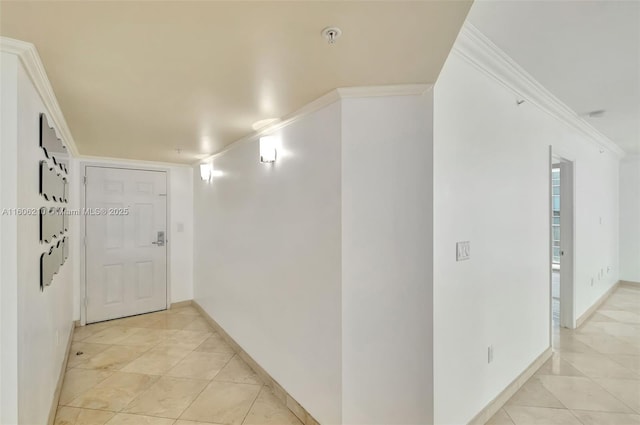 corridor with light tile patterned floors and ornamental molding