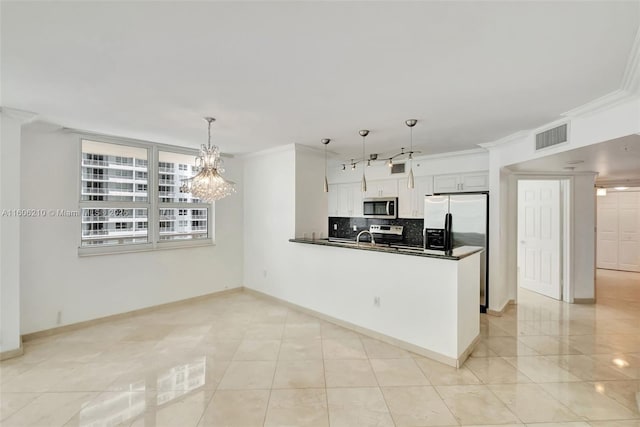 kitchen with white cabinetry, crown molding, stainless steel appliances, and pendant lighting