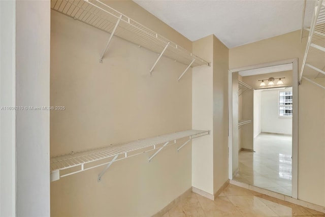 walk in closet featuring tile patterned flooring