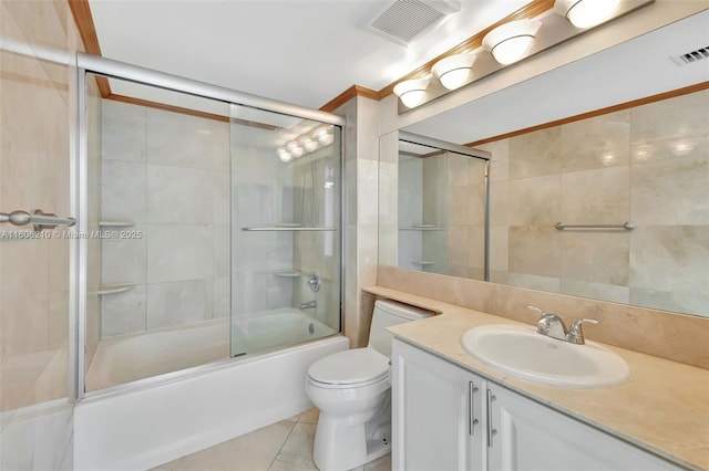 full bathroom featuring tile patterned floors, vanity, toilet, and enclosed tub / shower combo