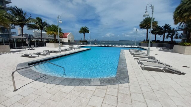 exercise room with a water view and floor to ceiling windows