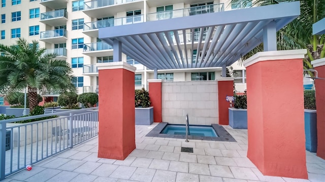 exterior space with a pergola and a hot tub