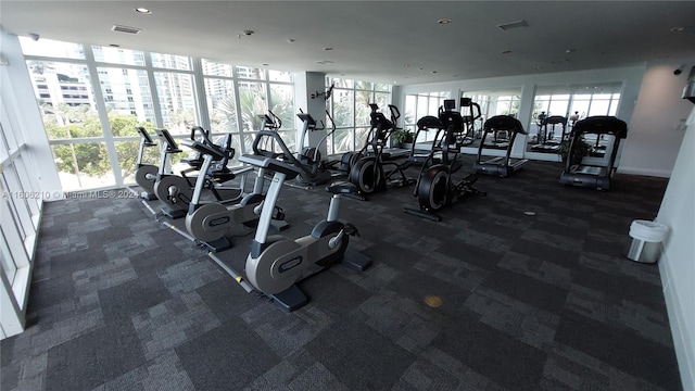 exercise room featuring dark carpet