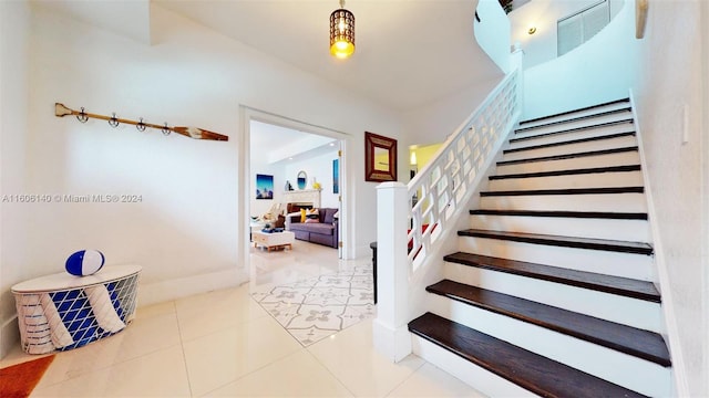 staircase featuring tile patterned flooring