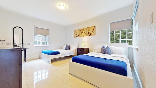 bedroom with light tile patterned floors