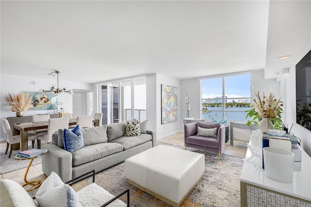 living room with floor to ceiling windows, light tile patterned floors, and a chandelier