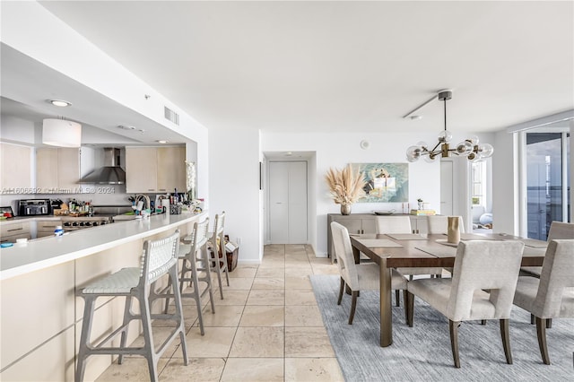 tiled dining space with an inviting chandelier