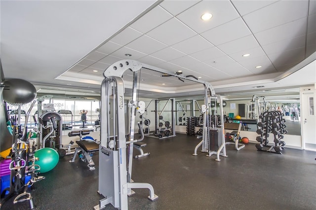 workout area featuring a paneled ceiling and a raised ceiling