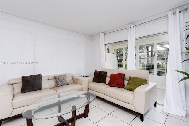 living room featuring ornamental molding and light tile patterned flooring