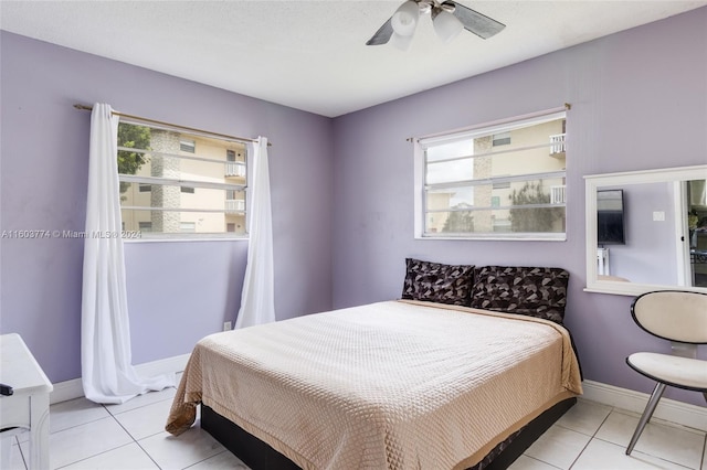 tiled bedroom featuring ceiling fan