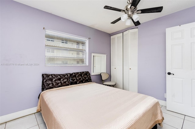 bedroom with light tile patterned flooring, ceiling fan, and a closet