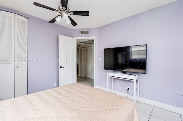 unfurnished bedroom featuring light tile patterned flooring, ceiling fan, and a closet