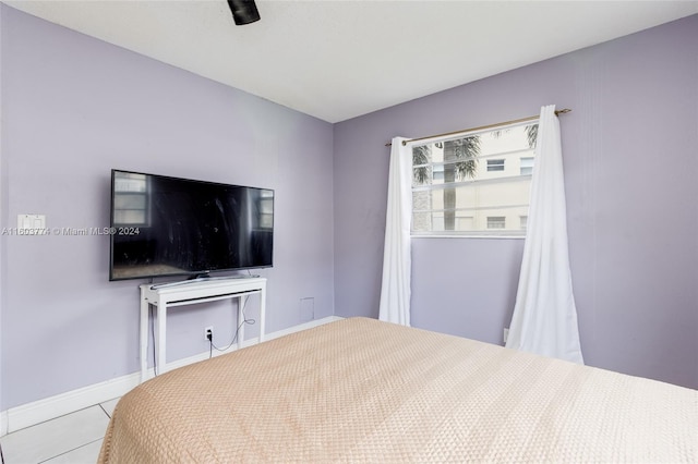 tiled bedroom with ceiling fan