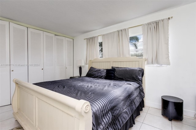 tiled bedroom featuring a closet