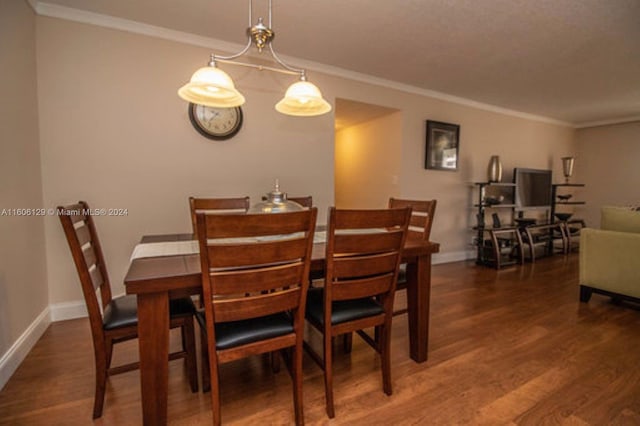 dining area featuring crown molding and dark hardwood / wood-style flooring