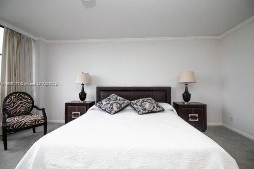 carpeted bedroom with crown molding