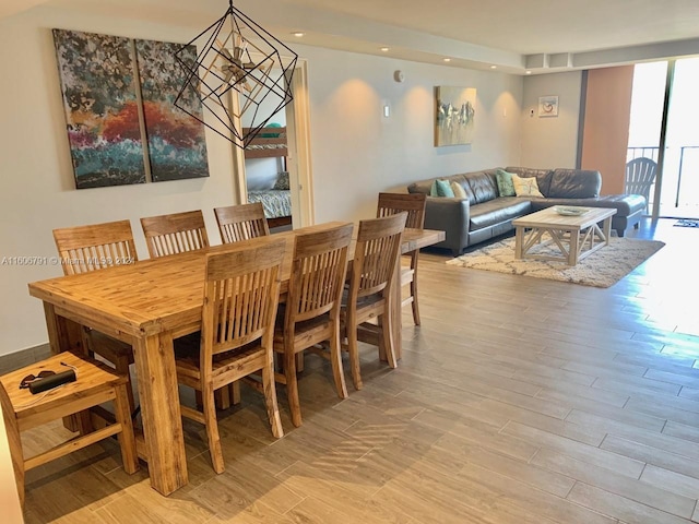 dining area featuring light hardwood / wood-style flooring and a chandelier